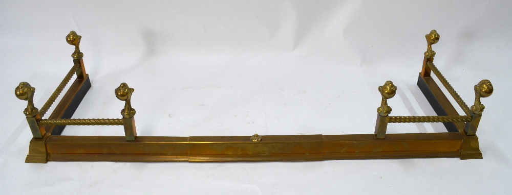 An adjustable brass hearth fender with c