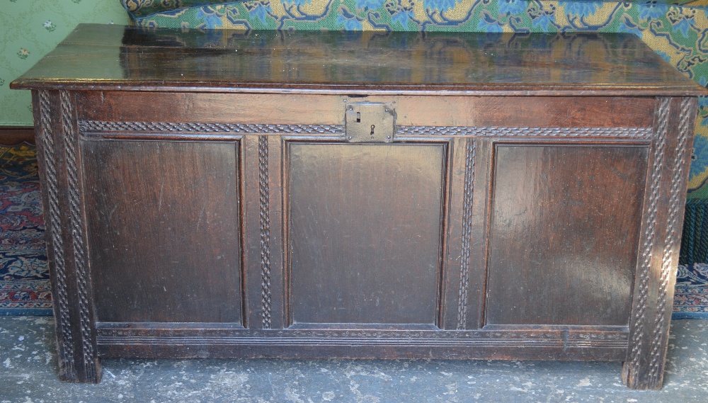 An early 18th century oak coffer, the wi