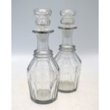 A pair of glass decanters and stoppers;