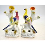 A pair of Victorian Staffordshire spill vases depicting a fancy bird perched on a branch,
