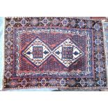A South West Persian rug with linked ivo