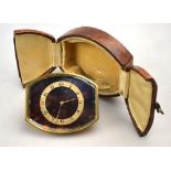 A Swiss Art Deco gilt brass strut clock, the tortoiseshell tonneau dial with silvered chapter ring,