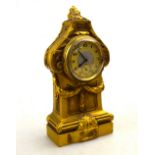 A small French ormolu desk clock cast with foliate scrolls and garlands,