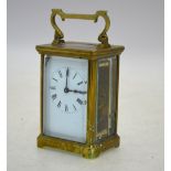 An English brass carriage clock with enamel dial,