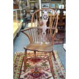 An early 19th century Windsor yew wood and elm hoop back elbow chair,