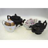 A black basalt teapot, unmarked; a black monochrome teapot, un-marked; a teapot with spiral design,