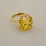 A square yellow sapphire ring, yellow metal four claw setting,