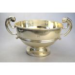 An Edwardian heavy quality silver rose bowl with twin scroll handle and raised foot, Walker & Hall,