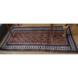 An old Belouch rug, the stylised flower head design on red/brown ground, 1.77 x 1.