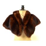 A brown musquash fur cape, three mink hats (brown,