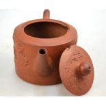 A brown/red stoneware cylindrical teapot and cover,