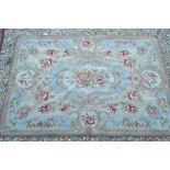 An Aubusson rug, traditional design on pale blue ground, 1.80 x 1.