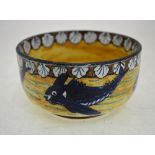 An Arts & Crafts circular bowl painted with blue spinney fish below a border of scallop shells,
