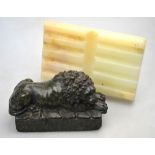 A carved serpentine stone recumbent lion, 9 x 14 cm,