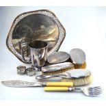 Four various silver-backed hairbrushes and a silver napkin ring,