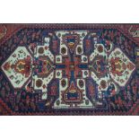 A Persian Bakhtiari rug, dark blue and cream ground,