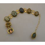 An Egyptian revival scarab-decorated yellow metal bracelet