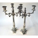 A pair of three-branch electroplated candelabra on reeded pillars and foliate-cast bases,