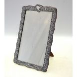 A late Victorian easel mirror with bevelled plate and pierced silver surround,