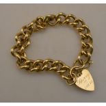 A heavy 9ct gold curb link bracelet with heart shaped padlock attached, approx 68.