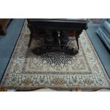 A Persian Quorn small carpet, floral design on dark blue ground,