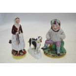 Three Victorian Staffordshire figures - Country woman holding a dead rabbit,