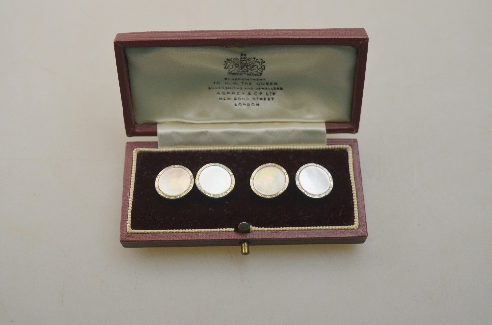 A pair of 9ct yellow and white gold mother of pearl set cufflinks in fitted box retailed by Asprey