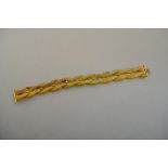 A yellow metal bracelet formed of four mesh chains plaited as a rope twist,