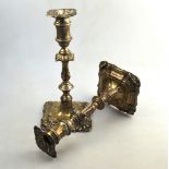 An Edwardian pair of loaded silver baluster candlesticks on ornate square bases, 23.