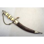 An Asian dagger with 20 cm etched and curved blade, the bone handle with eagles head pommel,