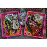 Two wooden boxes both containing a small quantity of vintage jewellery including bead necklaces,