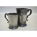 A Victorian pewter quart beer mug with scroll handle to/w a similar pint mug,