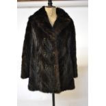 A dark brown mink jacket with double buttons to front, retailed by Charles Moss Furs,