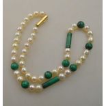 A cultured pearl necklace with cylindrical and spherical malachite beads interspersed throughout