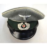 A WWII Third Reich officer's peaked cap, with cast alloy eagle and oak leaves insignia,