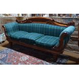 A Regency mahogany framed sofa with green tartan upholstery, raised on turned legs,