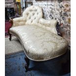 A Victorian walnut framed chaise with arched button back end and shaped arm over an overstuffed,