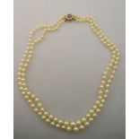 A double row graduated cultured pearl necklace on amethyst and split pearl three row cluster snap