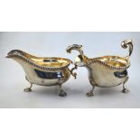 A matched pair of heavy quality silver sauce boats in the Georgian manner, with gadrooned rims,