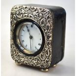 An Edwardian leather-cased desk clock with embossed silver face, Birmingham 1904,