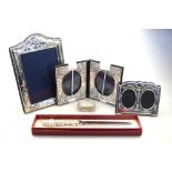 Three small photograph frames with silver surrounds, to/w a gilt-lined pill box,