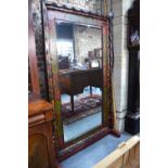 A large rectangular floor standing Indonesian bevelled mirror,