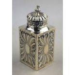 A Victorian embossed silver tea caddy of square form with domed cover, William Comyns & Sons,