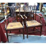 A set of six mahogany dining chairs in the Georgian style with shaped and moulded back rails over