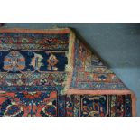 An old Persian Sarouk carpet, the floral vine design on dark coral ground, 4.10 x 2.