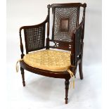 An Edwardian Sheraton Revival polychrome decorated satinwood bergere armchair,