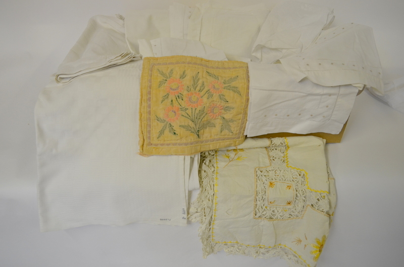 Two boxes of assorted table linen to include a set of placemats, tablecloths,