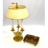 A brass three-branch table lamp with adjustable shade,