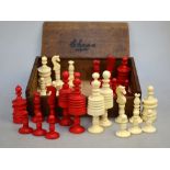 WITHDRAWN A 19th century ring-turned bone chess-set with red dye, in oak box, the king 9.