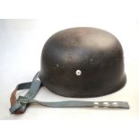 A rare WWII Third Reich paratroopers helmet stamped '4135' to inner rim c/w original leather liner